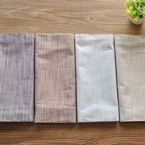 French style striped cotton linen napkins in four colors on a dark wood background