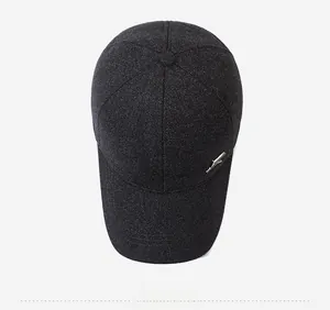 Top view of dark grey baseball cap showing textured wool fabric and metal bird ornament