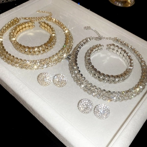 Close-up of sparkling rhinestone necklace, bracelet and earrings set on a white tray