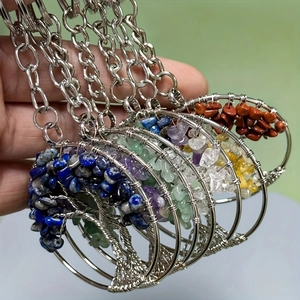 Detail of handmade Tree of Life pendants with natural crystals and silver wire wrap