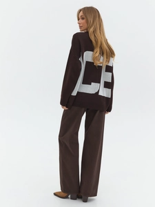 Detailed back view of brown knit sweater featuring white CE jacquard lettering