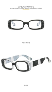 Detail of vintage rectangular glasses with black marble mottling and thick striped temples