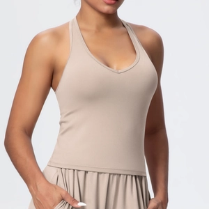 Detail of camel V-neck ribbed sports bra with elastic knit fabric and racerback design