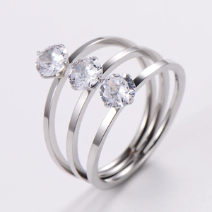 Macro shot of triple-layer silver rings with three prong-set round sparkling zircons
