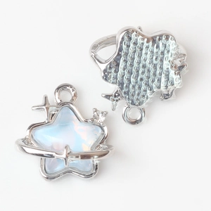 Detailed view of silver star and planet charms with iridescent opal and zircon stones