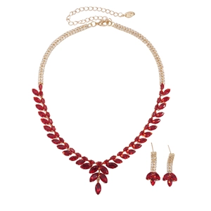 Parure de bijoux dorée de luxe avec feuilles en zircon rouge sur fond blanc pur
