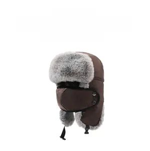 Detail of dark brown winter trapper hat with gray faux fur lining and chin strap