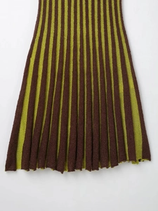Close-up of green and brown vertical stripe knitted pleats on sleeveless dress hem