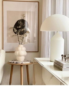 Close-up of a white bubble ceramic vase with a matte mushroom lamp in a Nordic setting