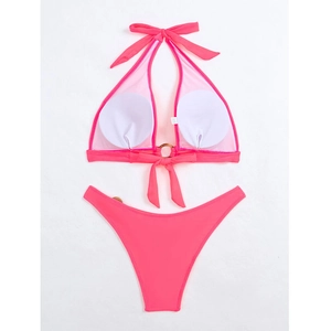 Close-up of neon pink halter bikini with wooden rings and removable white chest pads