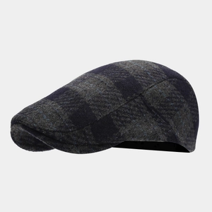 Close-up of vintage navy plaid newsboy cap with premium wool blend texture and stitching