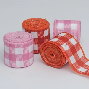 Close-up of pink and orange plaid Christmas ribbons with reinforced stitched edges