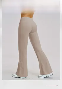 Back view of high waisted flared yoga pants in beige showing slimming fit and lift effect