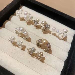 Detailed close-up of French vintage open rings with multi-color pearls and zircon