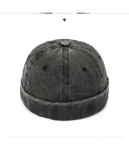 Detailed front view of black washed denim docker hat with metal ventilation eyelets