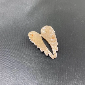 Back view of gold angel wing brooch showing the secure horizontal pin closure mechanism