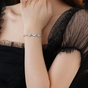Detailed close-up of adjustable silver bracelet with three oval cubic zirconia stones