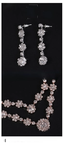 Macro detail of silver necklace and earrings set featuring sparkling zircon snowflakes