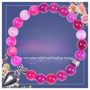 Detail of 8mm green agate bead bracelet with silver heart pendant and healing card