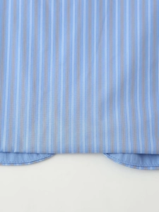 Macro shot of striped pajama pants hem with high-quality blue and brown vertical stripes