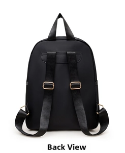 Detailed back view of women's black nylon backpack showing adjustable straps and gold buckles