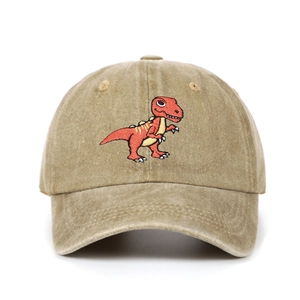 Detail of embroidered cartoon T-Rex dinosaur on khaki washed cotton kids baseball cap