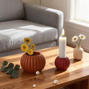 Pumpkin ribbed ceramic vase and candle holder set on wood table in minimalist room