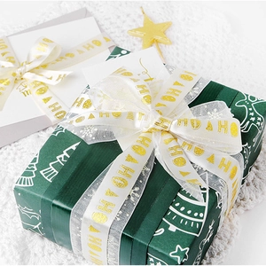 White Christmas ribbon with golden HO HO HO print for elegant gift box wrapping