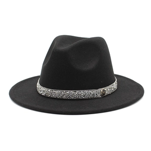 Close-up of black wool fedora featuring a rhinestone band and gold M letter charm