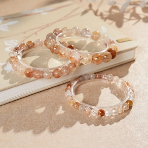 Detailed view of red rutilated quartz beaded bracelets with natural inclusions