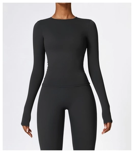 Detail view of high-stretch matte black yoga set with round neck top and leggings