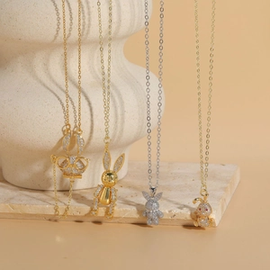 Detailed display of four distinct rabbit pendants with gold and silver zircon settings
