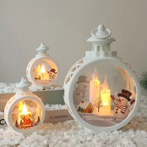 Three sizes of white Christmas LED lanterns with miniature Santa and snowman scenes inside