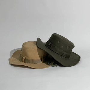 Detail view of khaki and olive green tactical boonie hats with metal vents and chin straps
