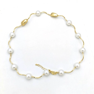Detail of pearl necklace with gold wavy links, lobster clasp and adjustable extension chain