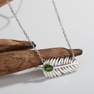 S925 sterling silver feather pendant necklace featuring a natural oval green gemstone