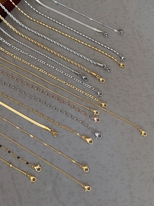 Macro detail of various titanium steel link chains in gold, silver and rose gold finishes