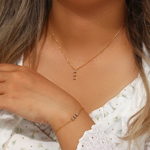 Detail of 18K gold plated necklace and bracelet set with three cubic zirconia stones