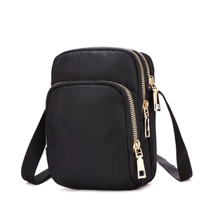 Three-layer black nylon crossbody phone bag with gold zippers and adjustable strap