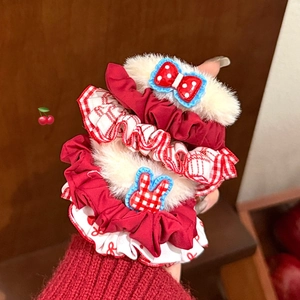 Close-up of red polka dot hair scrunchies with white faux fur and cute lace detailing