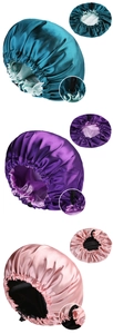 Detail view of adjustable buckles on dual-layer satin sleep caps in multiple colors