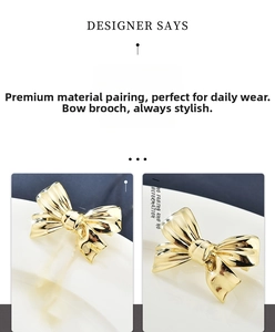 Detail view of a polished gold bow brooch showing its smooth metallic finish and elegant curve