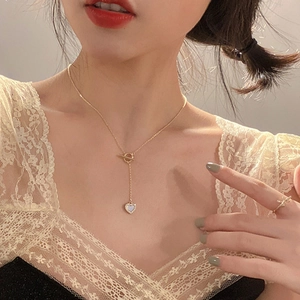Elegant gold titanium heart necklace with white mother-of-pearl and OT toggle clasp