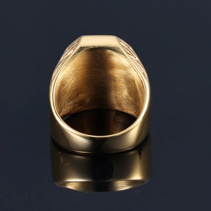 Macro view of gold signet ring showcasing brushed metal interior and polished surface
