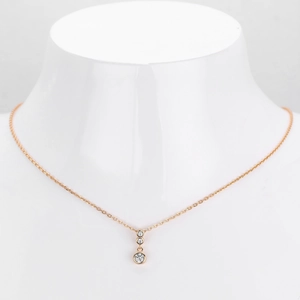 Detail of rose gold s925 silver necklace with three graduated round sparkling crystals