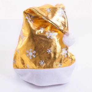 Close-up of golden Christmas hat with white snowflake patterns and plush trim