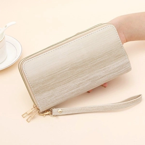 Detail of champagne gradient double zipper clutch with textured metallic finish and wristlet