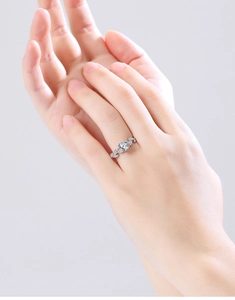 Detail of S925 silver ring featuring a round center stone and leaf-shaped side accents