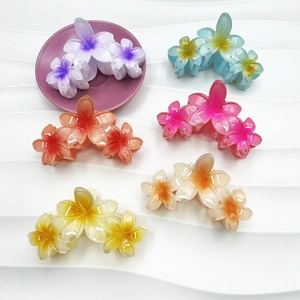Pack of six 11.5cm plumeria flower claw clips in vibrant gradient colors for hair styling