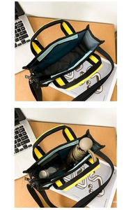 Detail view of black canvas tote interior capacity with blue lining for umbrella and bottle
